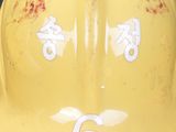 a yellow hard hat with numbers written on it