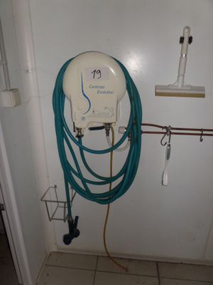 a white toilet with a blue hose attached to it