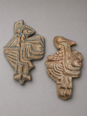 two ancient clay figurines of a man and a woman