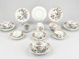 many different types of tea cups and saucers on the table