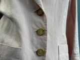 an image of a woman ' s jacket with buttons on it