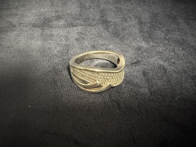 a close up of a gold ring on a black surface
