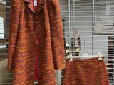a coat and a skirt on display in a store