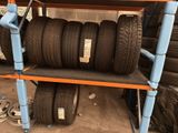many tires on a shelf in the garage
