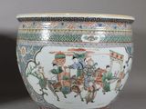 two chinese vases with figures on them sitting next to each other