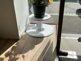 a potted plant sitting on a table in a window sill