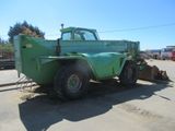 a green truck that is parked on the side of the road