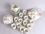 many cups and saucers that are sitting on a table
