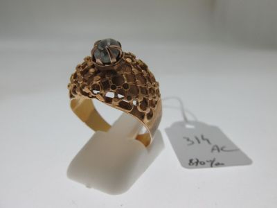 an image of a gold ring with a stone on top of it