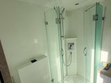 a bathroom with a toilet, shower, and sink in it