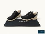 chanel black sneakers with white soles on a black mat