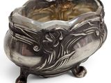 a silver bowl with a flower design on it