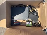 a box with a laptop, mouse, and other electronics in it