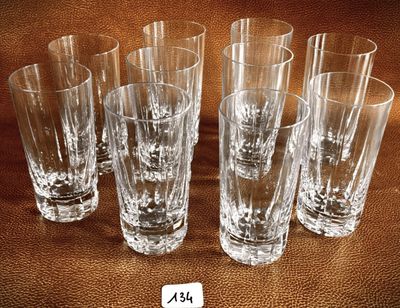 six shot glasses sitting on top of a brown table next to each other