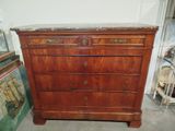 a wooden dresser with marble top in a room