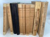several old books stacked on top of each other on a white surface