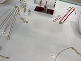 many necklaces and bracelets on display in a glass case