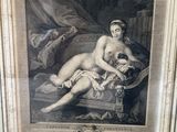 an old picture of a naked woman sitting on a couch
