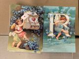 two cards with a picture of two cherensils and a heart
