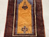a yellow rug with a blue and red design on it