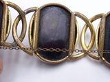 a person that is holding a bracelet that has a stone on it
