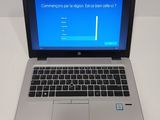 a laptop with a blue screen sitting on a table
