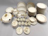 a lot of white and gold china dishes and cups