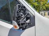a close up of a car ' s side mirror with a fan attached to it