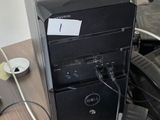 a desktop computer sitting on top of a desk next to a telephone