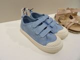 two pairs of blue shoes on a white table