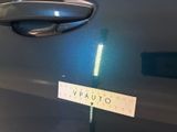 a close up of a car door handle with a sticker on it