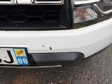 a close up of a white truck with a license plate on it