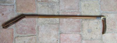 an image of a long handle on a brick floor