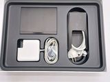 a box with a charger, headphones, and a charger on it