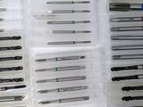a lot of different types of dental tools on the table