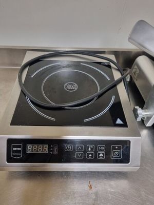 stainless steel counter top with a black burner on top of it