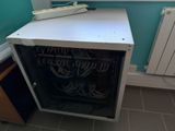 an image of a computer cabinet with a telephone on top of it