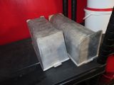 two pieces of metal sitting on top of a stove