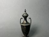 antique silver plated urn with lid on a grey background