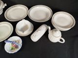 many plates and cups and saucers on the table