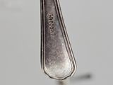 a silver spoon with a fork sticking out of it