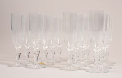 four clear wine glasses sitting on top of a white table