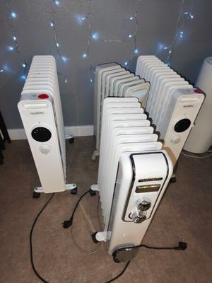 many white radiators that are lined up in a room