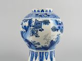 a blue and white vase sitting on top of a table