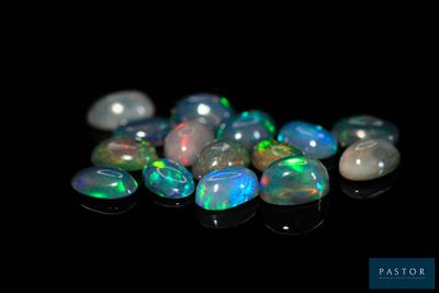 a close up of a bunch of oplite stones on a black surface