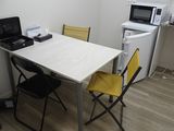 a small kitchen with a table and chairs in it
