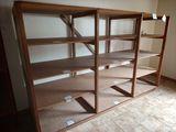 a room with a book shelf and a window