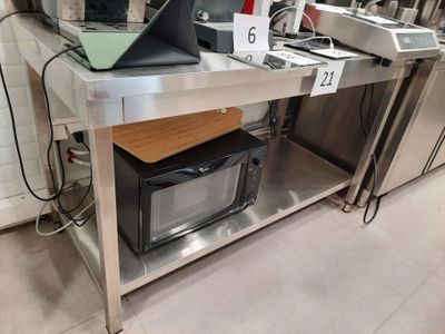 a laptop computer sitting on top of a table in a kitchen