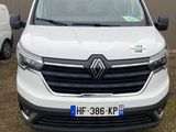 the front of a white van parked in front of a building