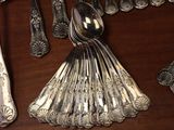 many silver spoons and spoon spoons on a table